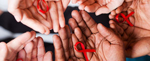 Lots of hands holding red ribbons. © Michael Jung/Fotolia